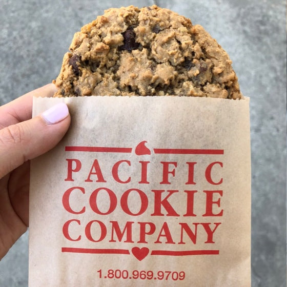 A cookie in a branded Pacific Cookie Company bag