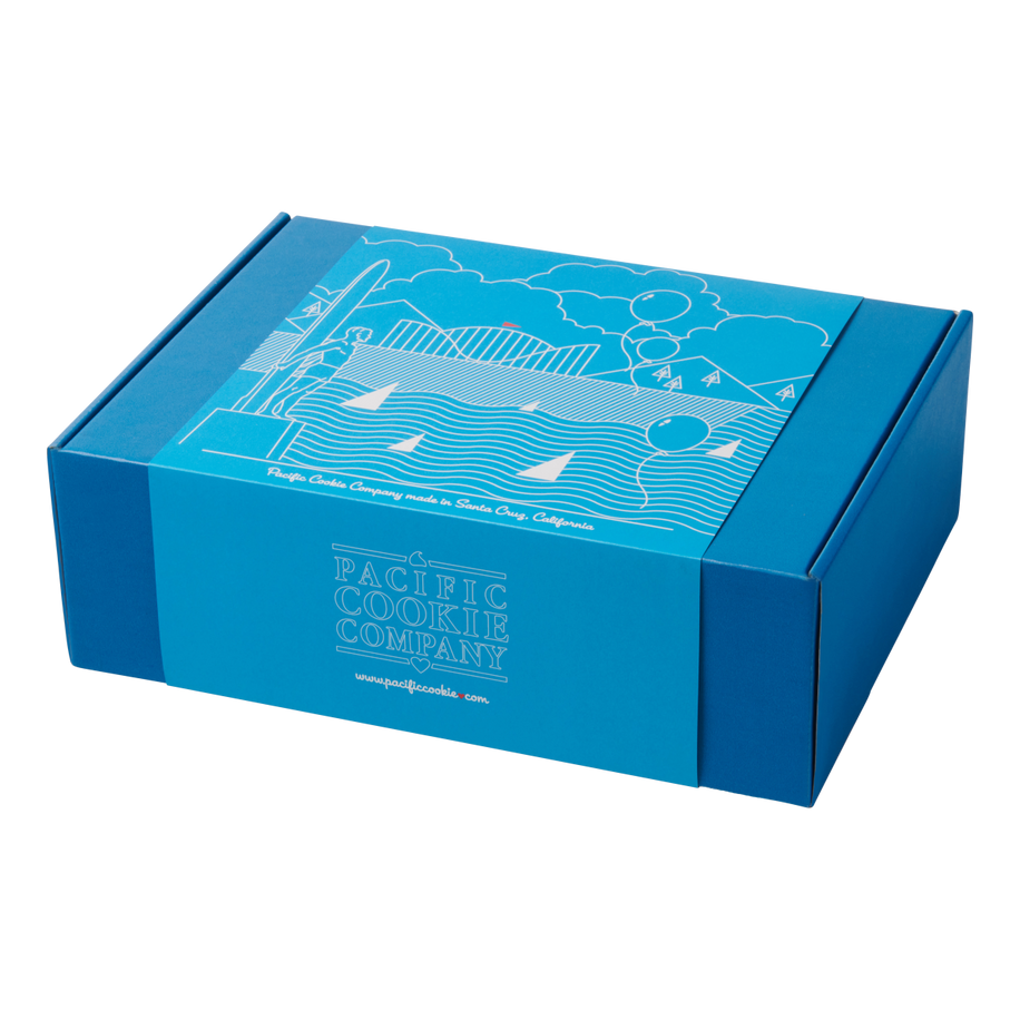 Blue gift box featuring white line art of the Santa Cruz Boardwalk, mountains, and Surfer Statue with a light blue background and Pacific Cookie Company branding on the front